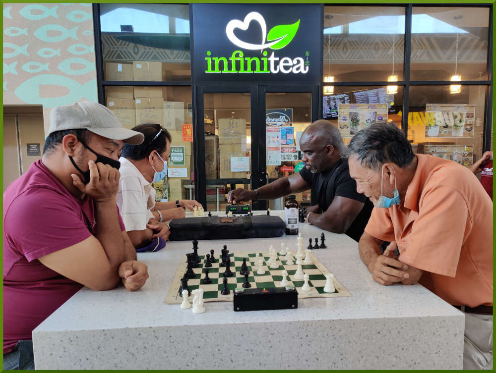 Two games of chess being played at Ka Makana Alii foodcourt.