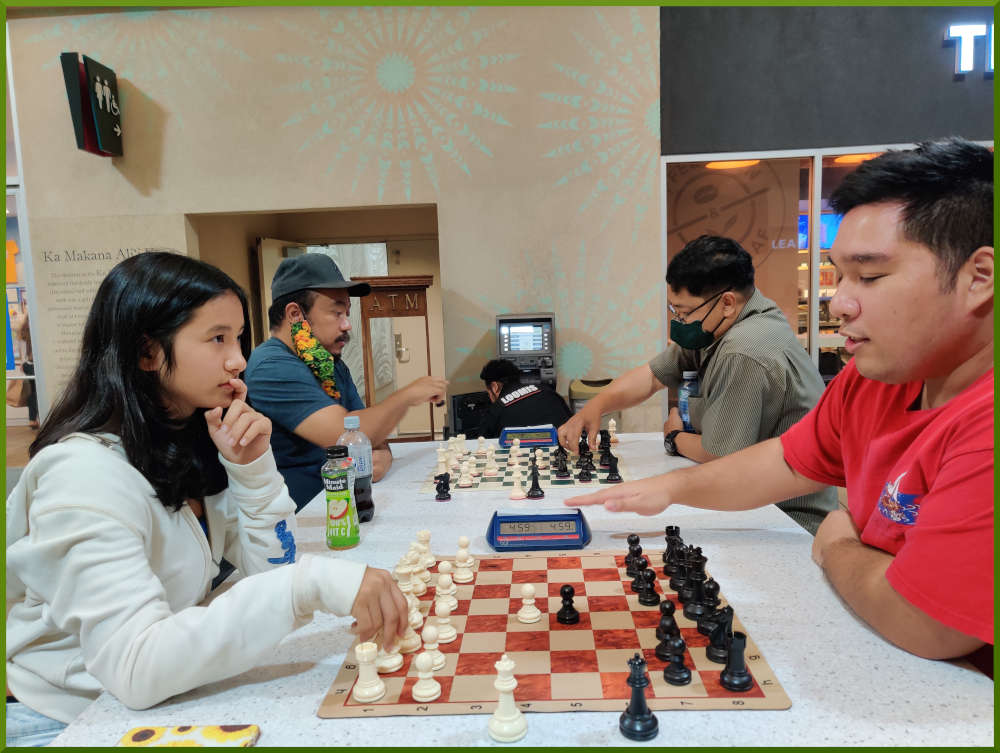 March 29th, 2022. Ka Makana Alii chess meetup. Mckenzie vs Ceazer (near board). Jeremy vs Jose (far board).
