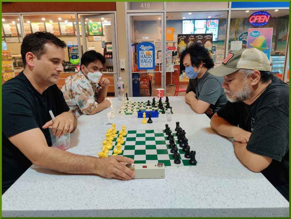 March 29th, 2022. Ka Makana Alii chess meetup. Ryan vs Chet (near board). Paul vs Peter (far board).