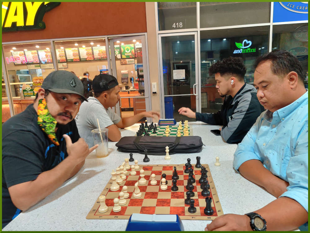 April 5th, 2022. Ka Makana Alii chess meetup. Jeremy vs Richard (near board). Shane vs Christian (far board).