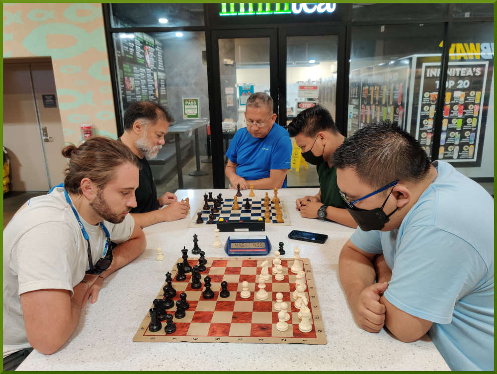 May 10th, 2022. Ka Makana Alii chess meetup. Ari vs John (near board). Chet vs Prince (far board).