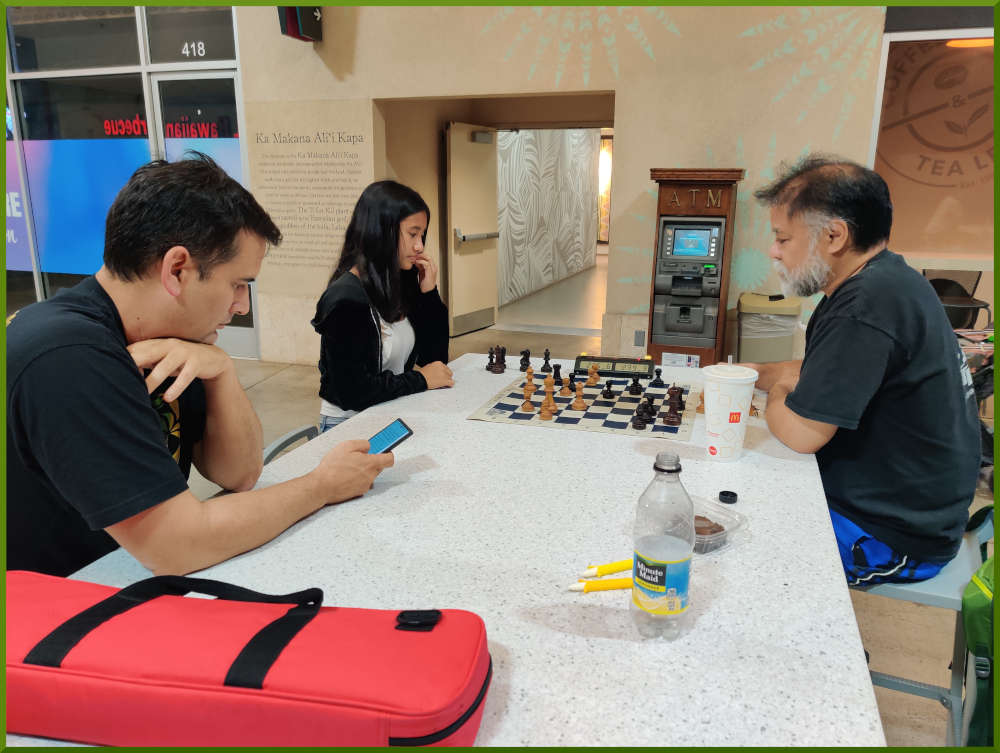 May 24th, 2022. Ka Makana Alii chess meetup. Mckenzie vs Chet. Ryan on his phone.