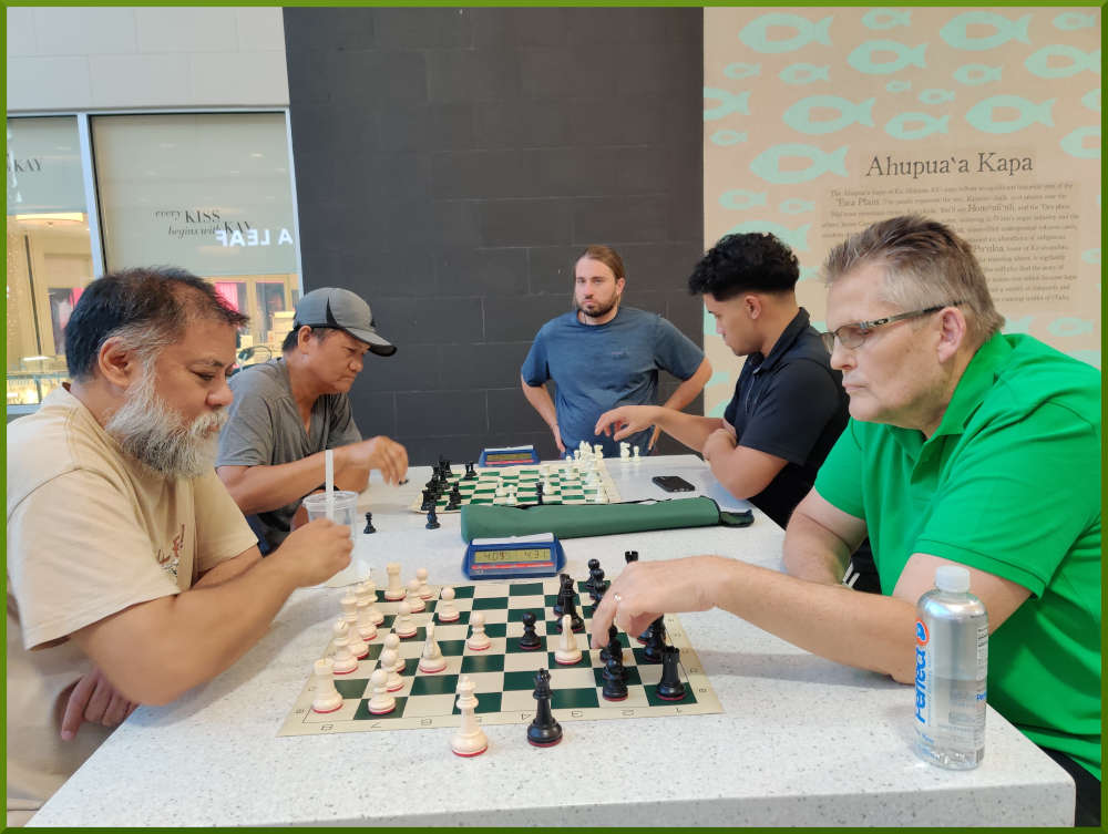 June 28th, 2022. Ka Makana Alii chess meetup. Chet vs Larry (near board). Edgar vs Christian (far board).