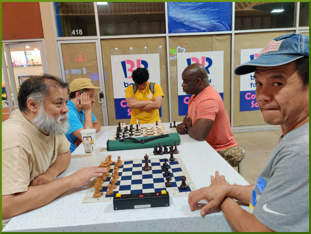 July 5th, 2022. Ka Makana Alii chess meetup. Chet waiting for challener (near board). Ari vs Ramon (far board).