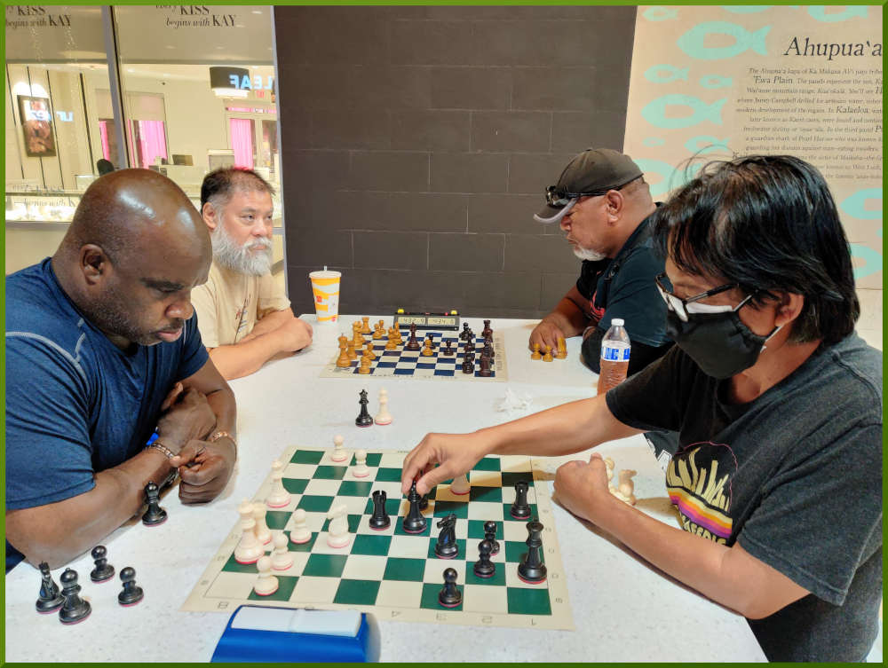 July 26th, 2022. Ka Makana Alii chess meetup. Ramon vs Regie (near board). Chet vs Fred (far boarrd).