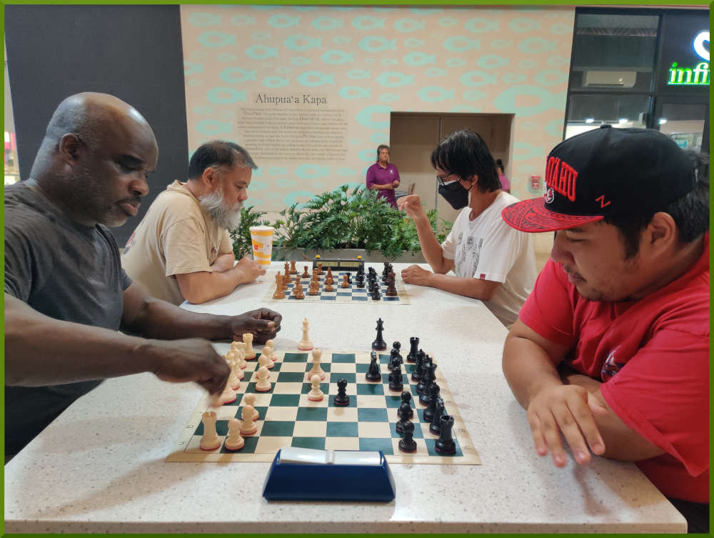 August 2nd, 2022. Ka Makana Alii chess meetup. Ramon vs Ceazar (near board). Chet vs Regie (far board).