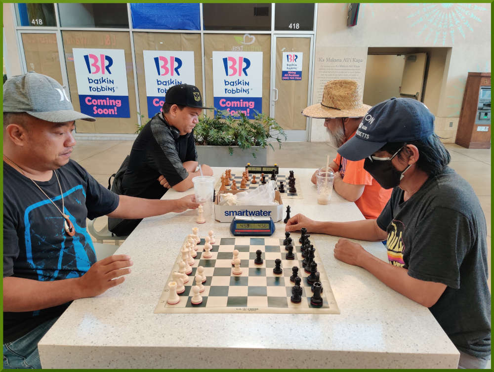 August 9th, 2022. Ka Makana Alii chess meetup. Jeremy vs Regie (near board). Nick vs Chet (far board).