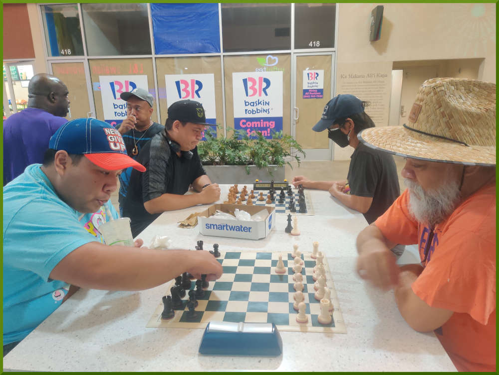 August 9th, 2022. Ka Makana Alii chess meetup. Ceazar vs Chet (near board). Nick vs Regie (far board).
