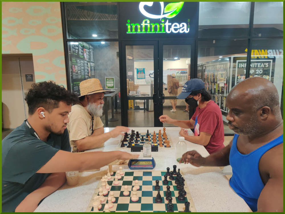 August 23rd, 2022. Ka Makana Alii chess meetup. Christian vs Ramon (near board). Chet vs Regie (far board).