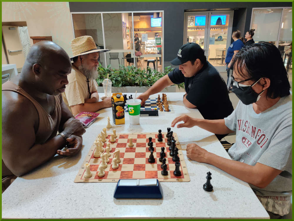 August 30th, 2022. Ka Makana Alii chess meetup. Ramon vs Regie (near board). Chet vs Ceazar (far board).