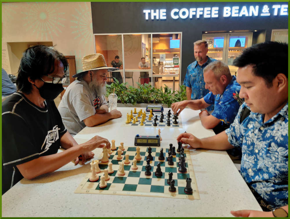 September 27th, 2022. Ka Makana Alii chess meetup. Regie vs Ceazar (near board). Chet takes on a random player (far board).