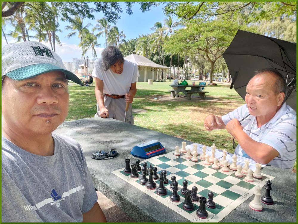 August 6th, 2022. Kapiolani park chess meetup. Ray vs Glenn. Napoleon waiting.